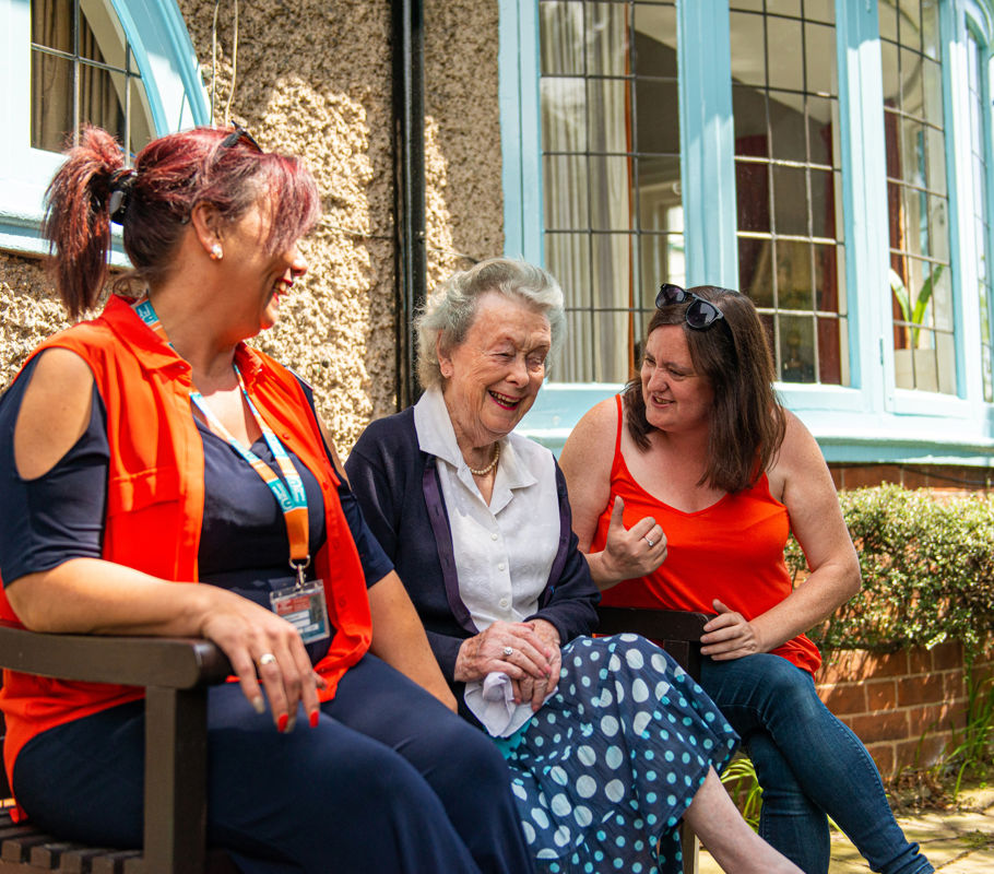 CareGivers and client talking on a bench