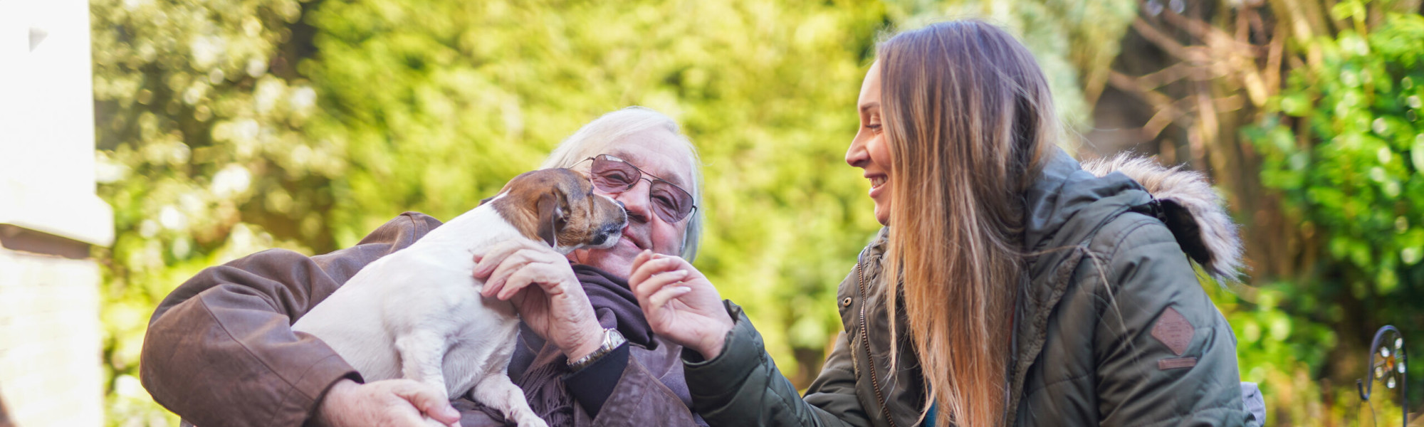 Client and CareGiver stroking dog