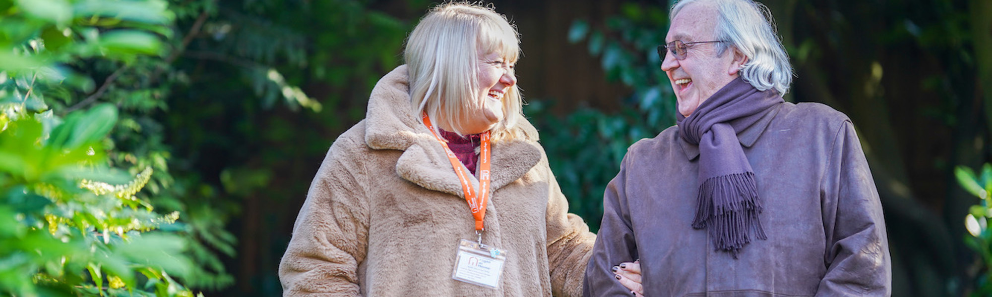 CareGiver and elderly man walking together