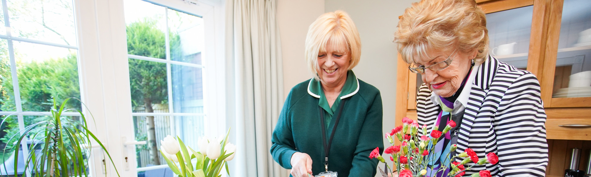 caregiver and client arranging flowers