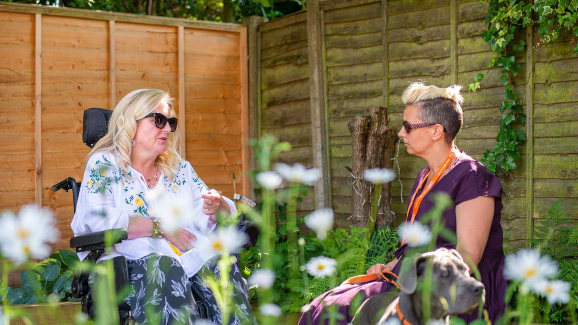 homecare professional and client chatting in garden