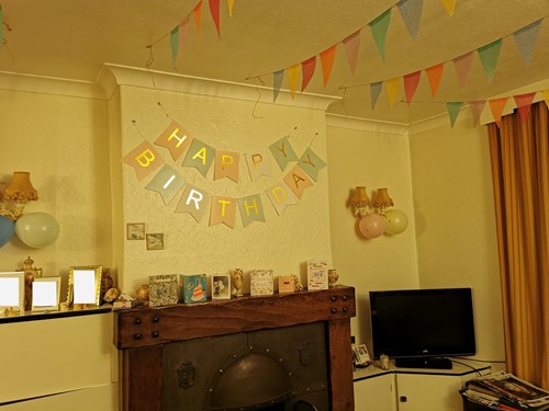 Decorated house with multi-coloured bunting and birthday banners